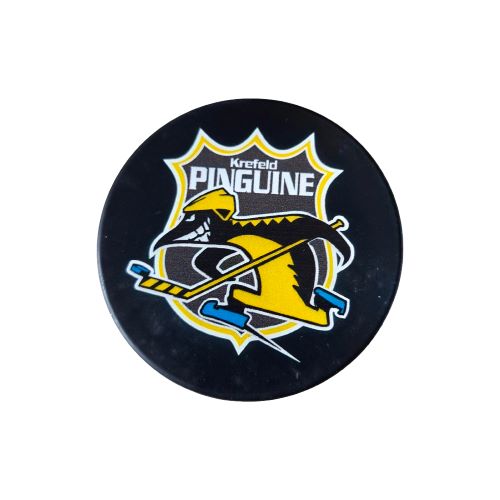 Krefeld Pinguine Eishockeypuck Retro Logo DEL Eishockey Fanartikel Merchandise Ein schwarzer Eishockeypuck aus Hartgummi mit dem aufgedruckten, nostalgischen Retro-Logo der Krefeld Pinguine auf der Vorderseite.